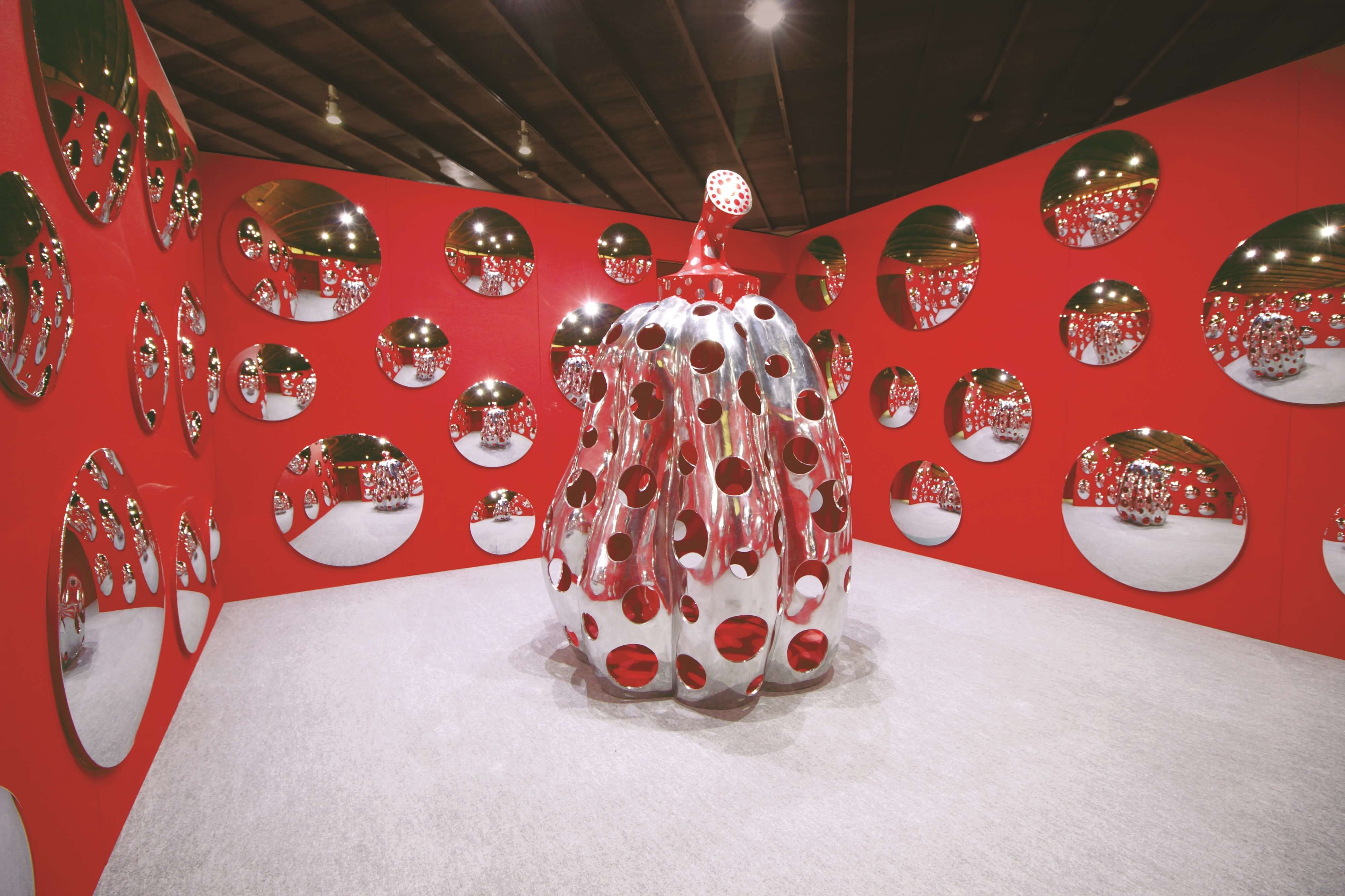 People use their smartphones to take pictures of the Yayoi Kusama